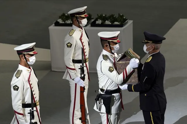 Color guards carry the remains of former Prime Minister of Japan Shinzo Abe during the state funeral Tuesday September 27, 2022, at Nippon Budokan in Tokyo. (Photo by Eugene Hoshiko/AP Photo)