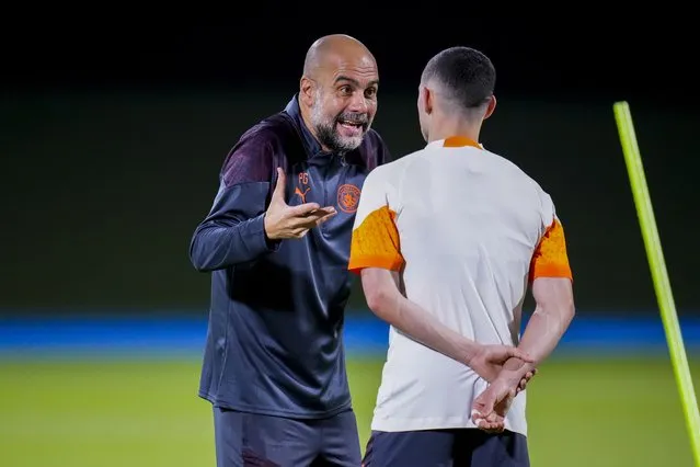 Manchester City's head coach Pep Guardiola, left, talks with Manchester City's Phil Foden during a training session at the King Abdullah Sports City Stadium in Jeddah, Saudi Arabia, Monday, December 18, 2023. Urawa Reds will play against Manchester City during the semifinal soccer match during the Club World Cup on Tuesday Dec. 19. (Photo by Manu Fernandez/AP Photo)