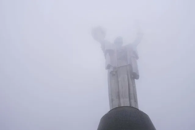The Motherland monument, which has just reopened for public viewing, is seen through fog in Kyiv, Ukraine, on Saturday, October 21, 2023. (Photo by Alex Babenko/AP Photo)