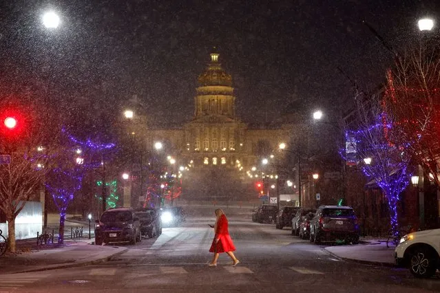 A woman crosses Locust Street in front of the Iowa State Capitol Building as a light and steady snow falls on January 08, 2024 in Des Moines, Iowa. Wintery weather forced Republican presidential candidate Nikki Haley to cancel a campaign event in Iowa earlier in the day, one week before the state's caucuses, the first Republican Party primary contest of the 2024 presidential election. (Photo by Chip Somodevilla/Getty Images)