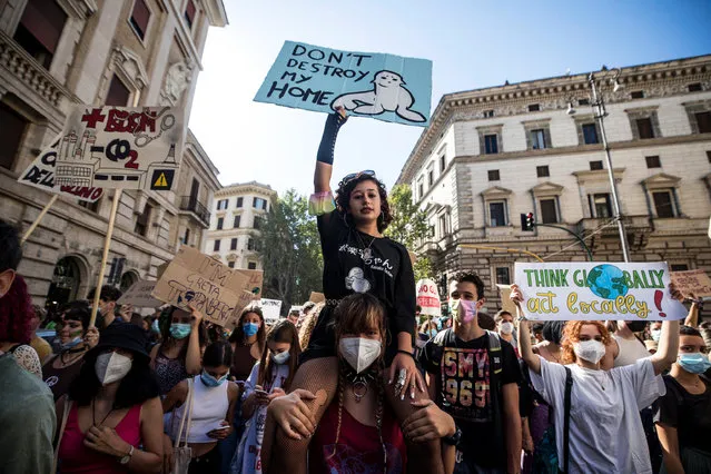 Protesters with signs and slogans during the Fridays for Future demonstration for the global climate strike in Rome, Italy, 24 S​eptember 2021. (Photo by Angelo Carconi/EPA/EFE)