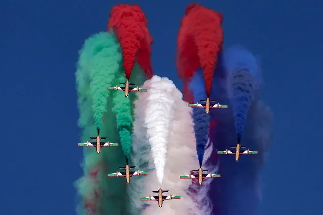 Aermacchi MB-339 trainer aircraft of the Fursan al-Emarat (UAE Knights) aerobatics team release smoke as they fly over during the 2023 Dubai Airshow at Dubai World Central - Al-Maktoum International Airport in Dubai on November 14, 2023. (Photo by Karim Sahib/AFP Photo)