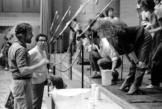 Actress-singer Bernadette Peters, star of Broadway's “Sunday in the Park with George”, leans forward to discuss the recording of the show's album with composer-lyricist Stephen Sondheim, left, and producer of the album Thomas Z. Shepard at the RCA Recording Studio in New York City, June 1984. (Photo by Marty Reichenthal/AP Photo)