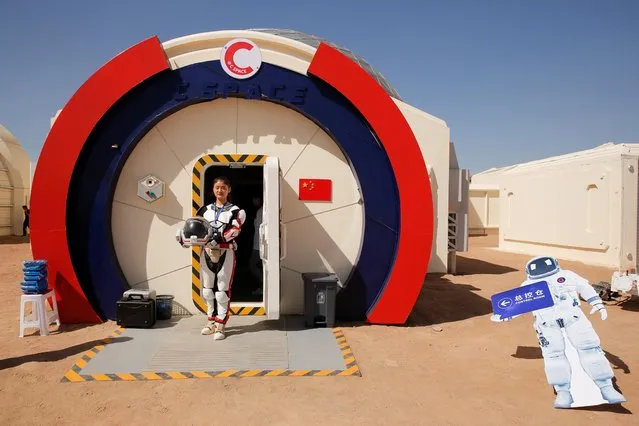 A staff member poses in a mock space suit at the C-Space Project Mars simulation base in the Gobi Desert outside Jinchang, Gansu Province, China, April 17, 2019. (Photo by Thomas Peter/Reuters)