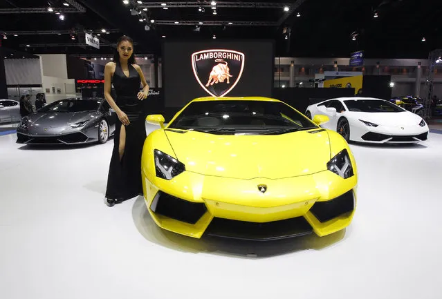 A model poses beside a Lamborghini Aventador LP700-4 during a media presentation at the 37th Bangkok International Motor Show in Bangkok, Thailand, March 22, 2016. (Photo by Chaiwat Subprasom/Reuters)