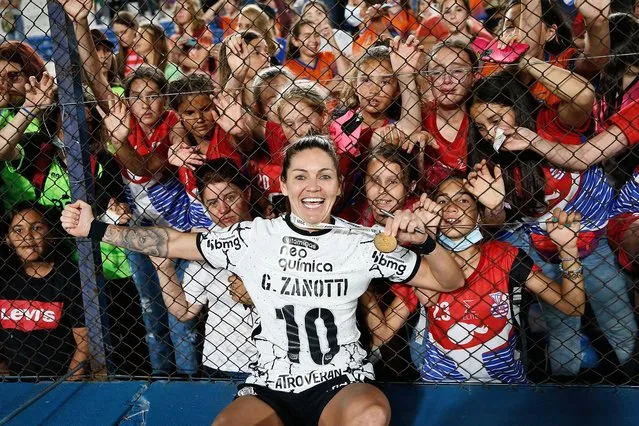Gabi Zanotti celebrates with fans after her team, the Corinthians from Brazil, beat Colombia’s Santa Fe 2-0 to win the women’s Copa Libertadores in Montevideo, Uruguay on November 21, 2021. The tournament is the most prestigious competition in South American club football. (Photo by Mariana Greif/Reuters)