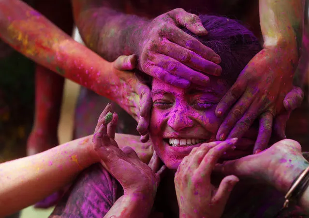 A girl reacts as others apply coloured powder on her face during Holi celebrations in Mumbai, India March 24, 2016. (Photo by Shailesh Andrade/Reuters)