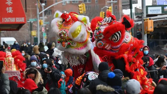 People celebrate the Lunar New Year holiday in Chinatown on February 12, 2021 in New York City. Friday marks the 2021 Lunar New Year, also referred to as Chinese New Year. This year will be recognized as the “Year of the Ox”, named after the second zodiac animal. (Photo by Angela Weiss/AFP Photo)