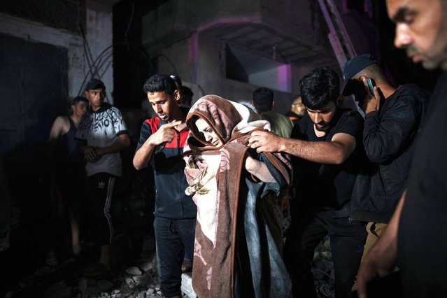 Palestinians evacuate injured members of the Abu Al-Anon family from under the rubble after an Israeli air strike hit their home in the Rafah refugee camp, southern Gaza Strip, May 4, 2024. More than 34,550 Palestinians and over 1,455 Israelis have been killed, according to the Palestinian Health Ministry and the Israel Defense Forces (IDF), since Hamas militants launched an attack against Israel from the Gaza Strip on 07 October 2023, and the Israeli operations in Gaza and the West Bank which followed it. (Photo by Haitham Imad/EPA)