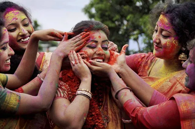 College girls celebrate with with coloured powders during Holi festival in Agartala, Tripura on Saturday, March 11, 2017. (Photo by Sushanta Das/PTI Photo)