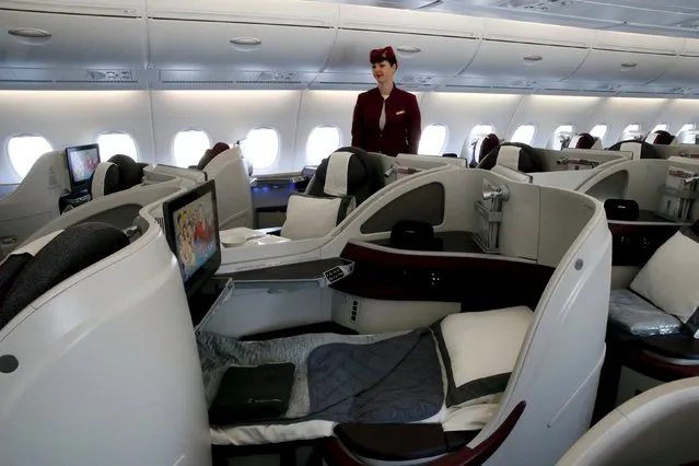 A Qatar Airways crew member presents the business class seats of an Airbus A380 aircraft during the 51st Paris Air Show at Le Bourget airport near Paris June 17, 2015. REUTERS/Pascal Rossignol 