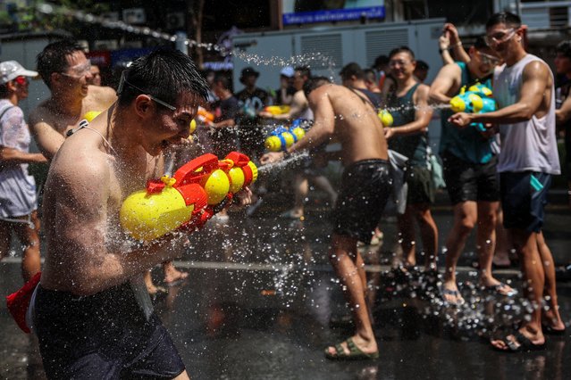Tourists play with water as they celebrate the Songkran holiday which marks the Thai New Year in Bangkok, Thailand, on April 13, 2024. (Photo by Chalinee Thirasupa/Reuters)