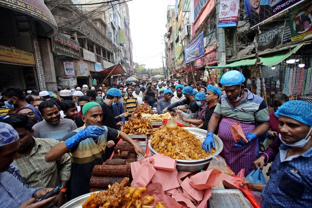 Bangladeshi Muslims buy food for breaking their fast during the first day of the fasting month of Ramadan at a traditional food market at Chalk bazar, in Dhaka, Bangladesh, 12 March 2024. The Muslims' holy month of Ramadan is the ninth month in the Islamic calendar, and it is believed that the revelation of the first verse in the Koran was during its last 10 nights. It is also a time for socializing, mainly in the evening after breaking the fast, and a shift of all activities to late in the day in most countries. (Photo by Habibur Rahman/ZUMA Press Wire/Rex Features/Shutterstock)