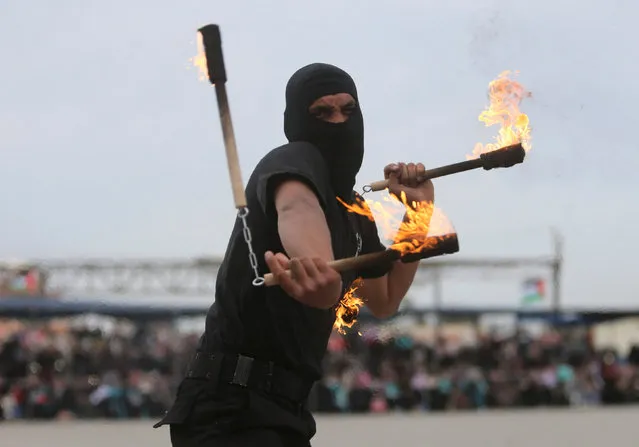 A Palestinian police officer loyal to Hamas demonstrates his moves during a graduation ceremony in Gaza City March 30, 2017. (Photo by Ibraheem Abu Mustafa/Reuters)