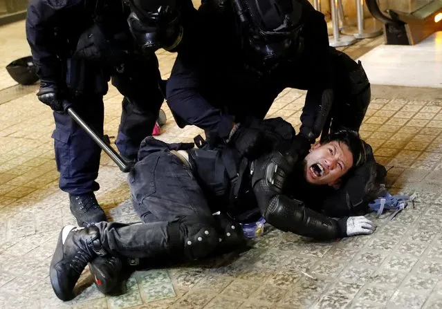 A demonstrator is detained by police officers during a protest in Hong Kong, China on August 31, 2019. Hong Kong police fired tear gas and water cannons and pro-democracy protesters threw petrol bombs in the latest in a series of chaotic clashes that have plunged the Chinese-ruled city into its worst political crisis in decades. (Photo by Kai Pfaffenbach/Reuters)
