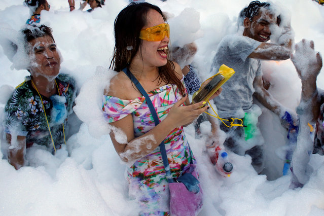 Revellers react at a foam party during Songkran Festival celebrations in Bangkok, Thailand April 13, 2017. (Photo by Jorge Silva/Reuters)