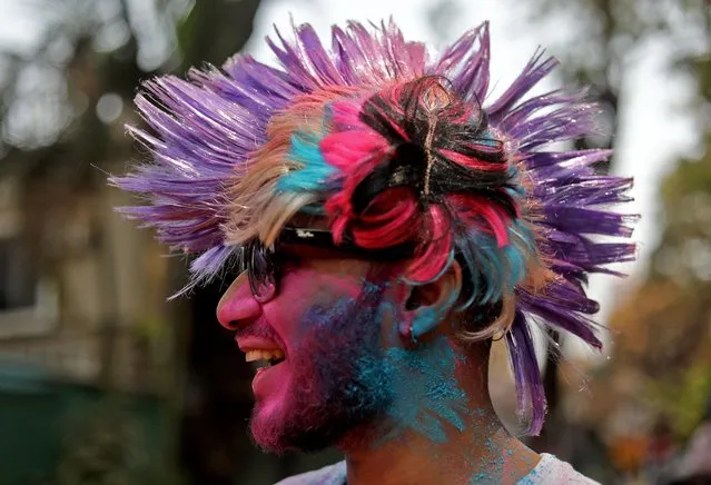A man wearing a colourful wig takes part in Holi celebrations in Mumbai, India, March 18, 2022. (Photo by Niharika Kulkarni/Reuters)