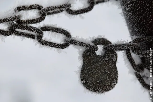 A frost covers a padlock and chain