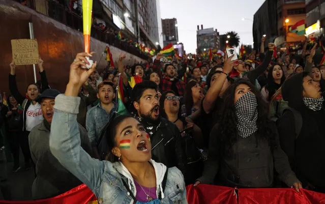 Anti-government protesters march demanding a second round presidential election in La Paz, Bolivia, Saturday, October 26, 2019. Bolivia's official vote tally was revealed Friday pointing to an outright win for incumbent Evo Morales in a disputed presidential election that has triggered protests and growing international pressure on the Andean nation to hold a runoff ballot. (Photo by Juan Karita/AP Photo)