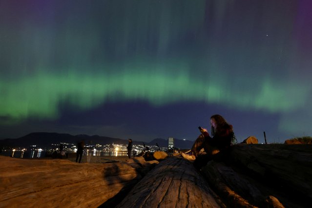 The aurora borealis, also known as the “northern lights”, caused by a coronal mass ejection on the Sun, illuminates the sky over Jericho Beach in Vancouver, British Columbia, Canada on May 10, 2024. (Photo by Chris Helgren/Reuters)