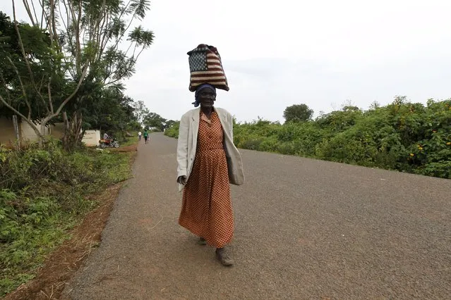 Rosa Anyango carries a bag with the colours of the U.S. flag as she walks from the market near the ancestral home of U.S. President Barack Obama in Kogelo village west of Kenya's capital Nairobi, June 22, 2015. (Photo by Thomas Mukoya/Reuters)
