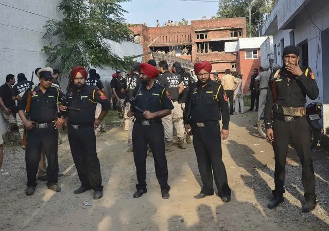 Indian security personnel stand at the site of a gunfight in Dinanagar town in Gurdaspur district of Punjab, India, July 27, 2015. (Photo by Mukesh Gupta/Reuters)