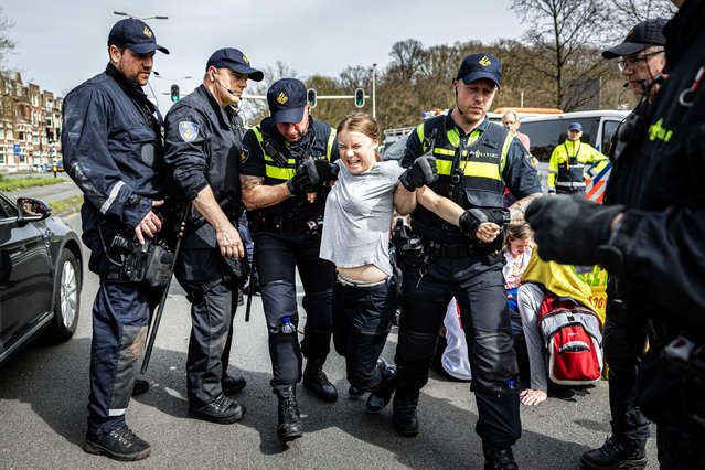 Swedish climate activist Greta Thunberg (C) is detained by police officers during a climate demonstration blocking the A12 highway in the Hague, the Netherlands, 06 April 2024. Thunberg joined the 37th highway blockade called by the Extinction Rebellion as new international actions against fossil subsidies were announced during the action. (Photo by Ramon van Flymen/EPA/EFE/Rex Features/Shutterstock)