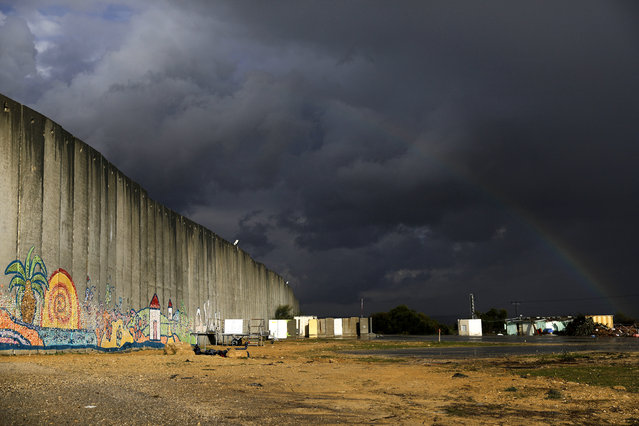A rainbow is seen over a concrete barrier in Netiv Haasara, southern Israel February 13, 2017. (Photo by Amir Cohen/Reuters)
