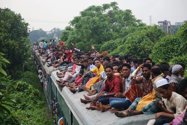 People travel home on an overcrowded train to celebrate Eid with family and friends in Dhaka, Bangladesh on June 3, 2019. (Photo by Rehman Asad/Barcroft Media)
