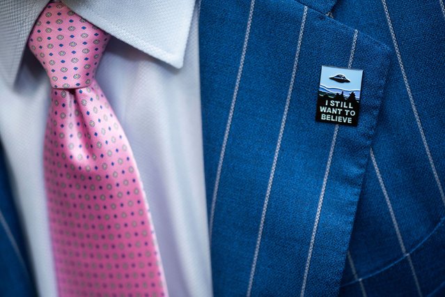 An audience member wears a “I Still Want to Believe” pin in Washington, DC, while attending a House hearing on unidentified anomalous phenomena – commonly known as UFOs – on Wednesday, July 26, 2023. Three retired military veterans testified at the hearing, warning that UFO sightings are a national security problem and that the government has been too secretive about them. (Photo by Nathan Howard/AP Photo)