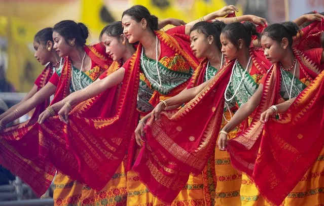 Indian Bodo tribal girls dance at an event to celebrate signing of a peace accord with the Bodo rebel group, National Democratic Front of Bodoland, in Kokrajhar, a town 250 kilometers (150 miles) west of Gauhati, India, Friday, February 7, 2020. Modi said on Friday that his government will continue its peace push in insurgency-wracked northeast bordering China and Myanmar where signing of accords with key rebel groups led to surrender by thousands of fighters. The prime minister said decades of violent insurrection ended in the Bodo tribal heartland in Assam state following the signing of the Jan. 27 agreement by the government with the rebel group. (Photo by Anupam Nath/AP Photo)