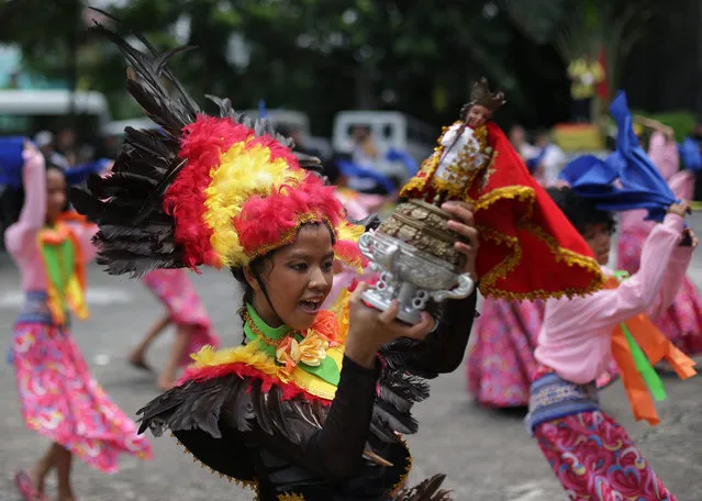 Filipino students dance with a replica of the Santo Nino de Cebu, an image of the baby Jesus, as it arrives in suburban Makati, south of Manila, Philippines on Sunday, August 16, 2015. The religious icon was brought to Manila to celebrate the 450th anniversary of its discovery in central Cebu province in the Philippines, Asia's largest Roman Catholic nation. (Photo by Aaron Favila/AP Photo)