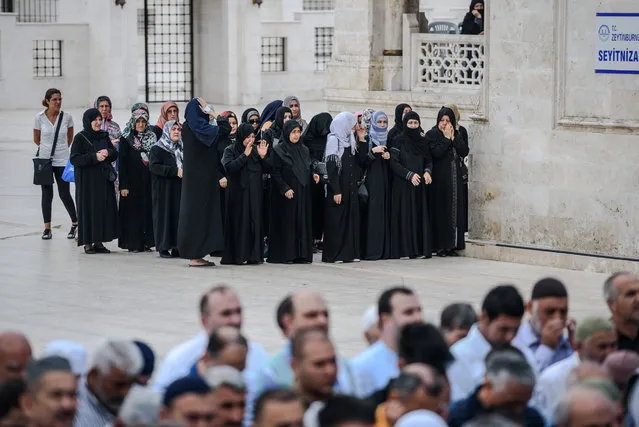 Women pray during the funerals of Maryam Amiri, Karime Amiri, Zahra Amiri and Huda Amiri on June 30, 2016 two days after they were killed by a suicide bombing and gun attack targeted Istanbul's Ataturk airport, killing 42 people. The death toll from the triple suicide bombing and gun attack that occurred on June 28, 2016 at Istanbul's Ataturk airport has risen to 43 including 19 foreigners. The government has pointed the finger of blame at the Islamic State group and Turkish police rounded up 13 suspected IS jihadists in raids at 16 different locations across Istanbul on June 30. (Photo by Ozan Kose/AFP Photo)
