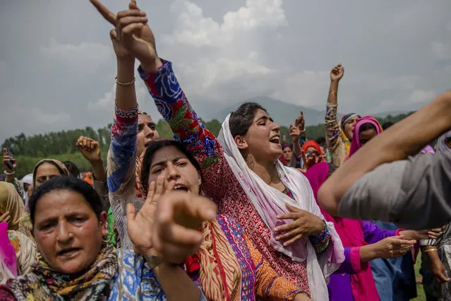 Kashmiri village women shout pro-Pakistani and pro-freedom slogans during the funeral procession of senior militant Arif Nabi Dar in Lilhar, about 35 kilometers (22 miles) south of Srinagar, Indian controlled Kashmir, Tuesday, August 1, 2017. Large anti-India protests and clashes spearheaded mostly by students erupted in disputed Kashmir on Tuesday after government forces killed two senior militants in a gunbattle and fatally shot a protester during an ensuing demonstration demanding an end to Indian rule. (Photo by Dar Yasin/AP Photo)