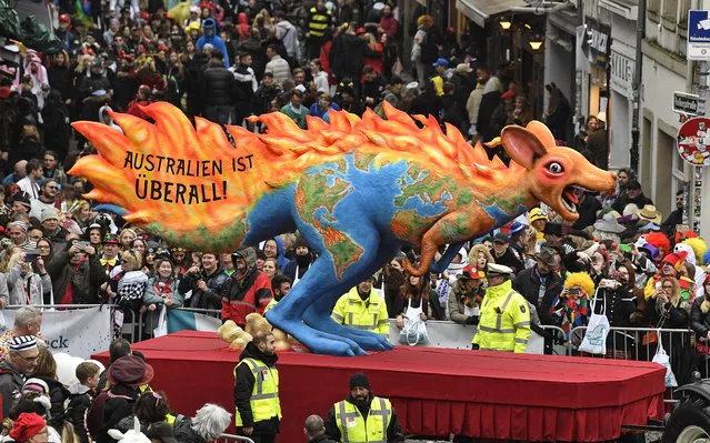A carnival float depicts a burning kangaroo, reading “Australia is everywhere” during the traditional carnival parade in Duesseldorf, Germany, on Monday, February 24, 2020. (Photo by Martin Meissner/AP Photo)