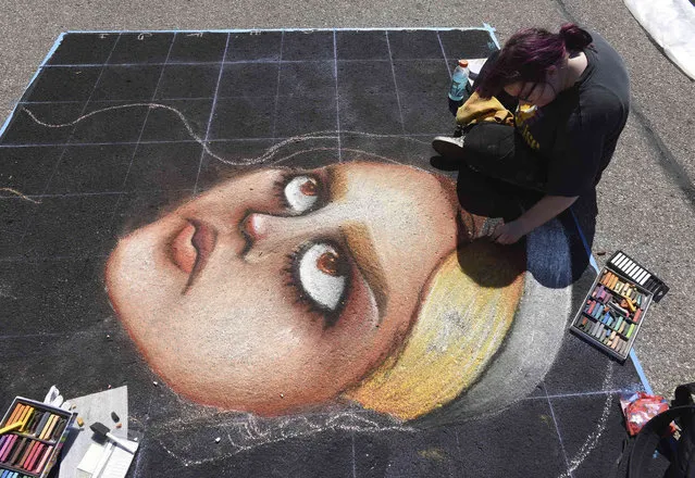 Jasmine Pilkinton, of Fort Wayne, Ind., works on a mural Saturday, August 6, 2022, during the annual Chalk the Block in downtown St. Joseph, Mich. (Photo by Don Campbell/The Herald-Palladium via AP)