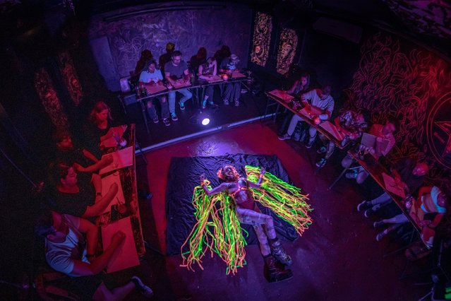 A model on September 4, 2024 draws in artists at the Neon Naked life-drawing class in London founded by Jylle Navarro, an artist and master’s graduate in art and science from Central Saint Martins. (Photo by Guy Corbishley/Alamy Live News)
