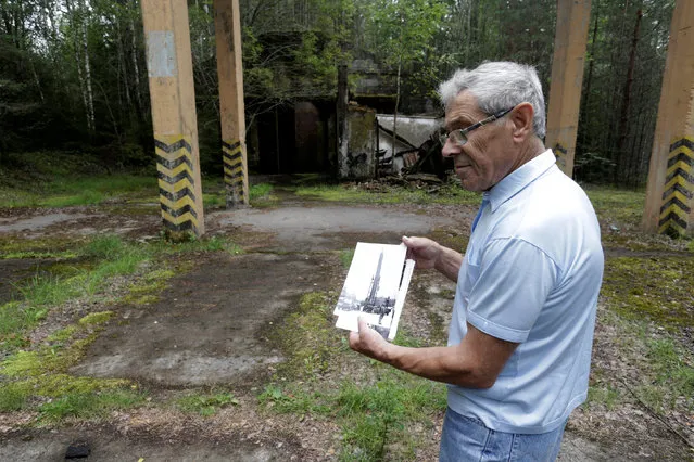 Former Soviet Army officer Vladimir Procenko shows a picture of the Soviet R12 nuclear missile near the abandoned launch site in Zeltini, Latvia, July 22, 2016. (Photo by Ints Kalnins/Reuters)