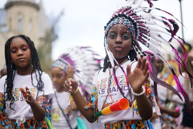 Young performers participate, during the children's parade on Family Day at the Notting Hill Carnival which returned to the streets for the first time in two years, after it was thwarted by the pandemic, in London, Sunday, August 28, 2022. (Photo by Victoria Jones/PA Wire via AP Photo)