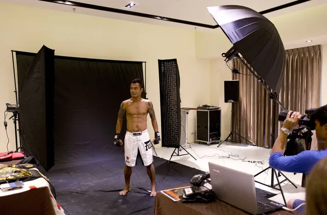 In this Thursday, July 16, 2015, photo, Dawna Aung, a member of the White New Blood lethwei fighters club, a Myanmar traditional martial-arts club which practices a rough form of kickboxing, poses for a photograph ahead of his lightweight-class fight for a mixed-martial-arts “One Championship” event broadcast globally on cable television networks, in Yangon, Myanmar. (Photo by Gemunu Amarasinghe/AP Photo)