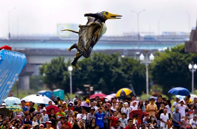 A participant dressed in a bird costume takes a flight during the Taiwan Birdman Competition in New Taipei City, Taiwan, on September 22, 2012. 60 teams and 280 competitors were registered for the human-powered flight competition. (Photo by Wally Santana/Associated Press)