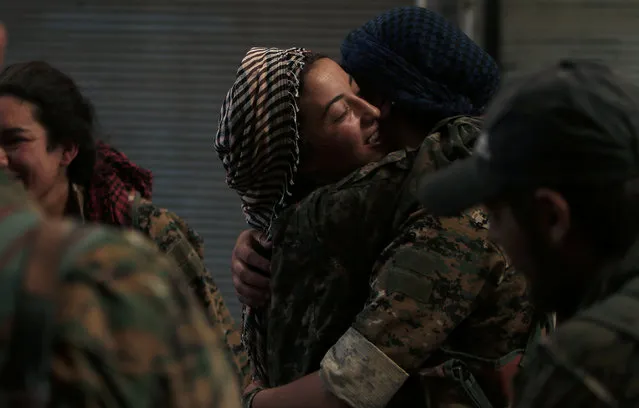 Syria Democratic Forces (SDF) female fighters embrace each other in the city of Manbij, in Aleppo Governorate, Syria, August 10, 2016. (Photo by Rodi Said/Reuters)