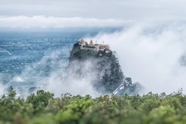 Popa Taungkalat Monastery is situated in the shadow of the nearby Mount Popa, a famous pilgrimage site in Myanmar. Visitors can climb 777 steps to this secluded Buddhist monastery to explore numerous shrines and see breathtaking views of the surrounding mountains. (Photo by Supoj Buranaprapapong via Getty Images)