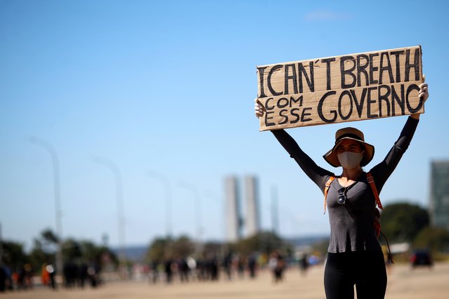 A protester wearing a face mask attends a demonstration against Brazilian President Jair Bolsonaro, racism and in support of democracy in Brasilia, Brazil June 7, 2020.Anger at the death of João Pedro and other recent complaints of police brutality are boiling over in Brazil against a backdrop of widespread U.S. demonstrations after the May 25 death of George Floyd in police custody. (Photo by Adriano Machado/Reuters)