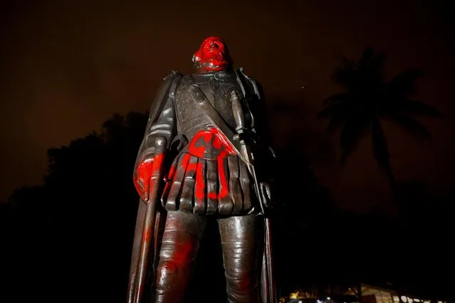 A vandalized statue of Christopher Columbus is seen at the Bayside Marketplace in downtown Miami, Florida, June 10, 2020. While Columbus was long hailed for opening the New World up to European civilization and settlement, present-day scholars acknowledge a more complicated legacy, including enslavement and subjugation of indigenous people. The statue in Miami was vandalized along with that of fellow explorer Ponce de Leon. Police said seven people were arrested in the incident, which they said grew violent. (Photo by Marco Bello/Reuters)