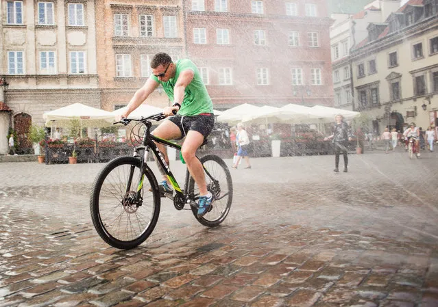 7: Warsaw, Poland. Latest ranking: 65; Ranking five years ago: 71; Five-year index movement: 2.1%. Here: A cyclist cools off on a hot day in the Polish capital. (Photo by NurPhoto via Getty Images)