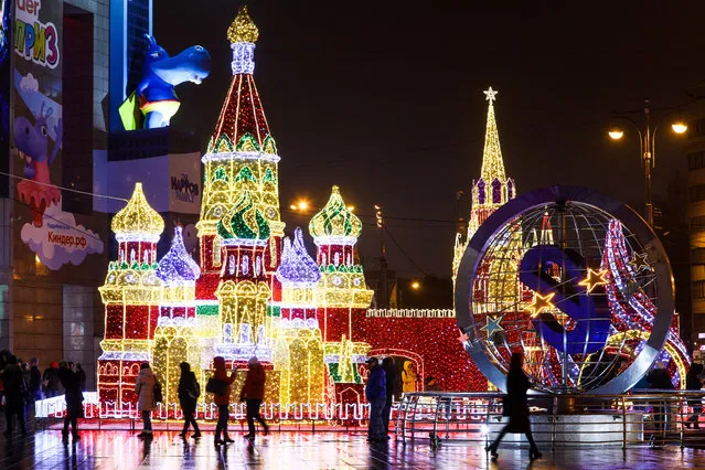 The Kremlin’s Spasskaya Tower and St Basil’s Cathedral are decked out in Christmas lights in Moscow, Russia on December 10, 2017. (Photo by Mikhail Tereshchenko/TASS)