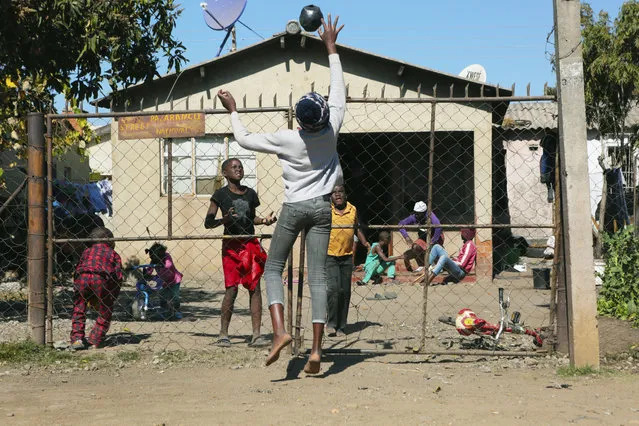 Children play with a ball outside a house, in Harare, Friday, July, 31, 2020. (Photo by Tsvangirayi Mukwazhi/AP Photo)