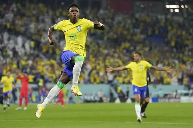 Brazil's Vinicius Junior celebrates after scoring his side's opening goal during the World Cup round of 16 soccer match between Brazil and South Korea at the Stadium 974 in Doha, Qatar, Monday, December 5, 2022. (Photo by Jin-Man Lee/AP Photo)