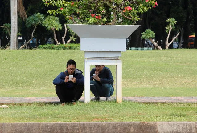 People play the mobile phone game Pokemon Go in a park in Central Jakarta, Indonesia July 21, 2016. (Photo by Iqro Rinaldi/Reuters)